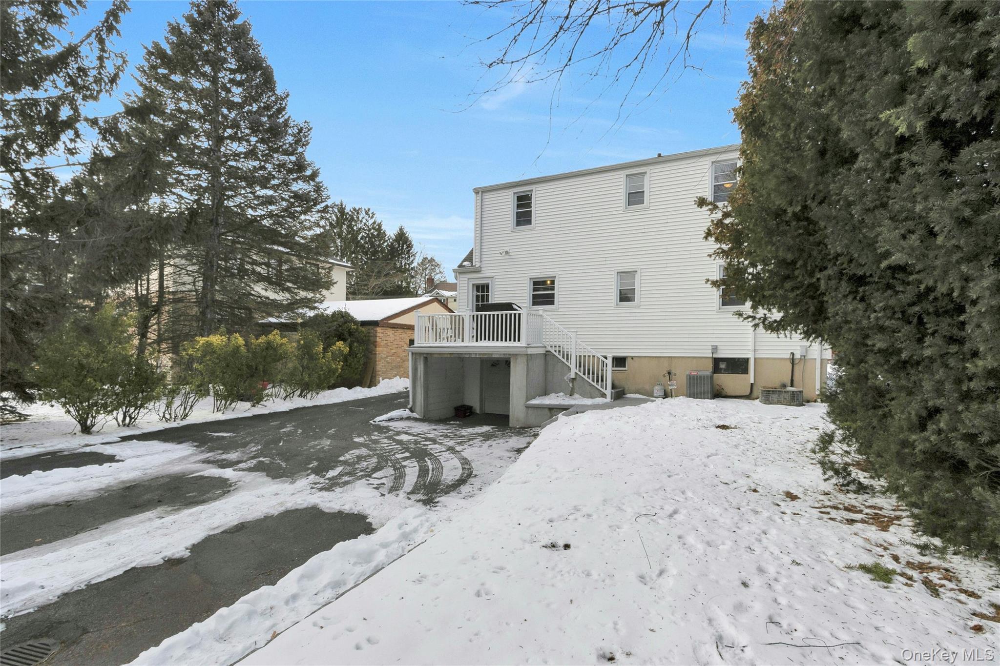 59 Sylvan Road Port Chester, NY 10573 - Photo 28 of 35 Rear view of the home with attached garage and so much more parking beyond the driveway at the rear