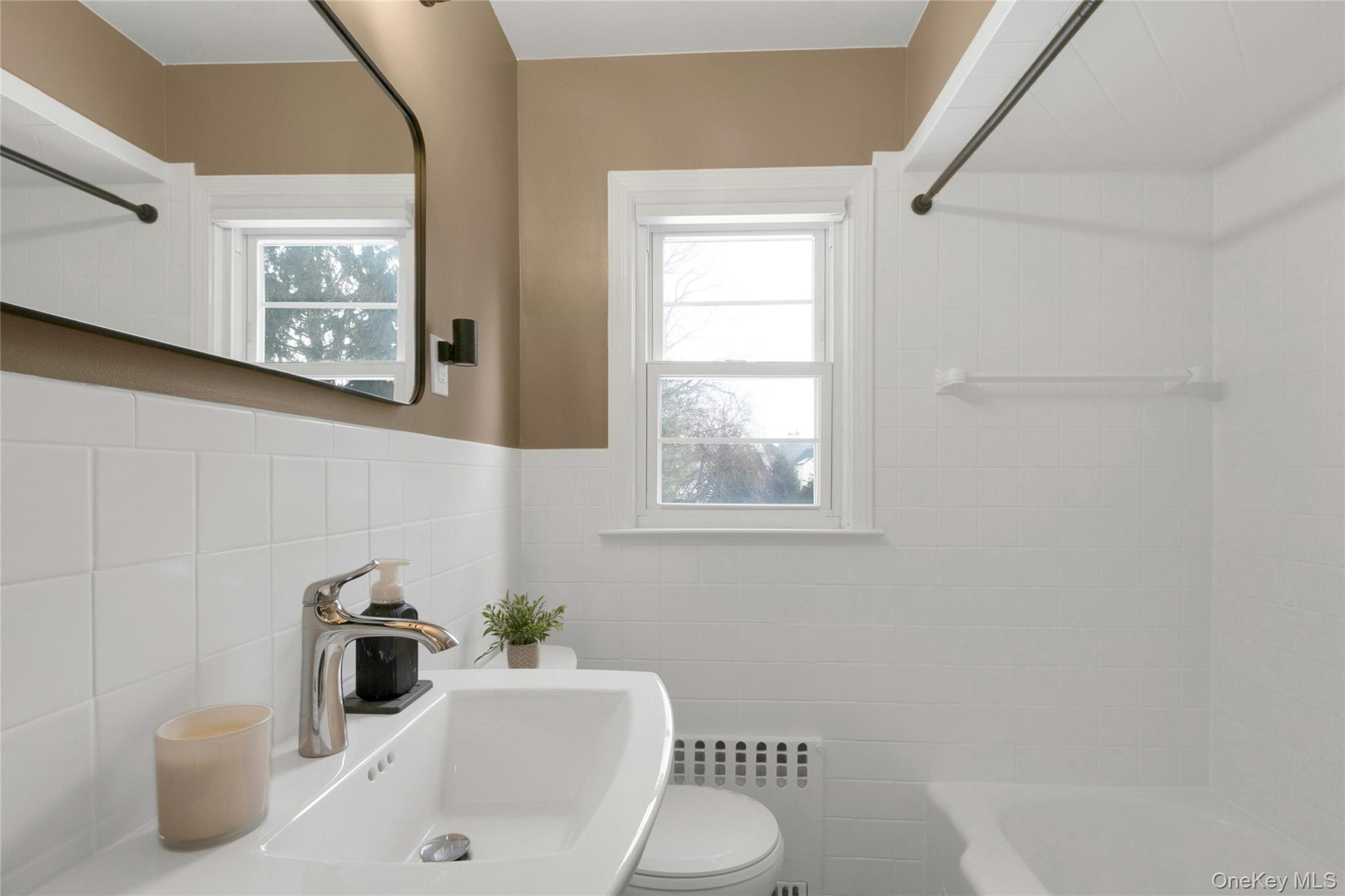 59 Sylvan Road Port Chester, NY 10573 - Photo 9 of 35 Full bathroom with window and plenty of natural light, tile walls, and a shower bath combination