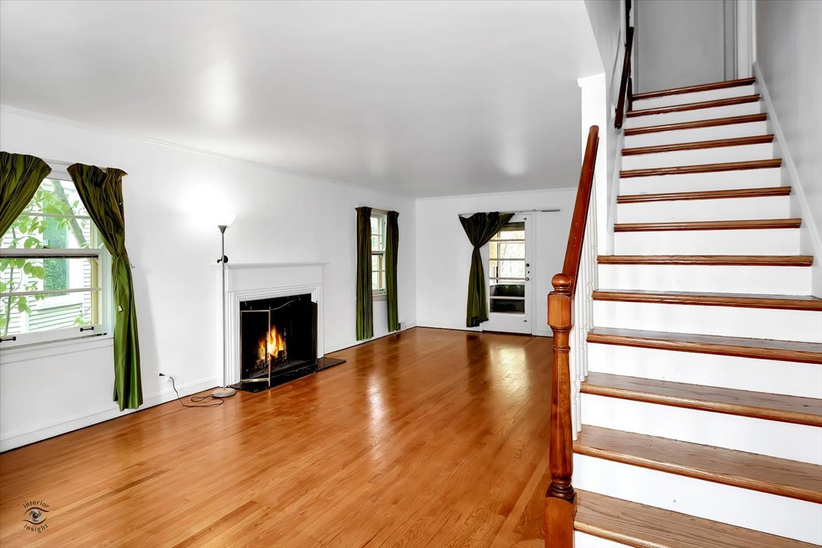 9527 South Damen Avenue Chicago, IL 60643 - Photo 2 of 30 a view of an empty room with wooden floor fireplace and a window