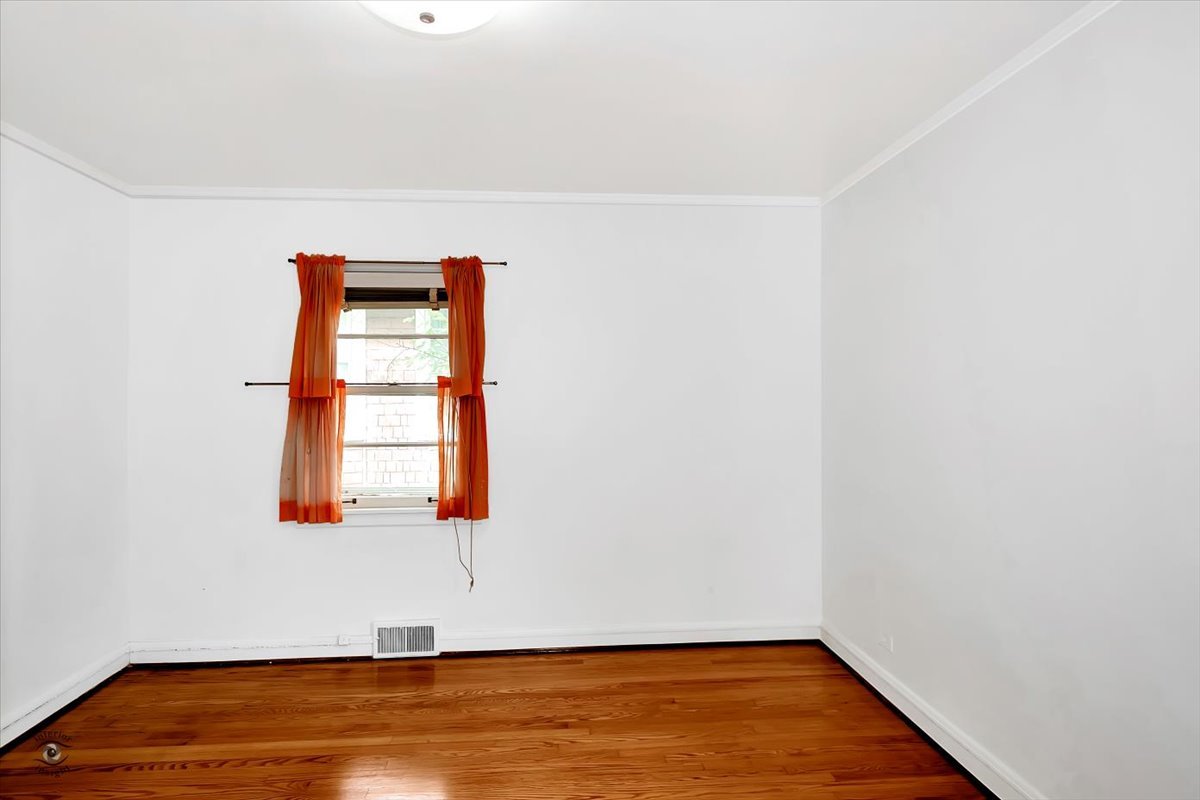 9527 South Damen Avenue Chicago, IL 60643 - Photo 23 of 30 an empty room with wooden floor and windows