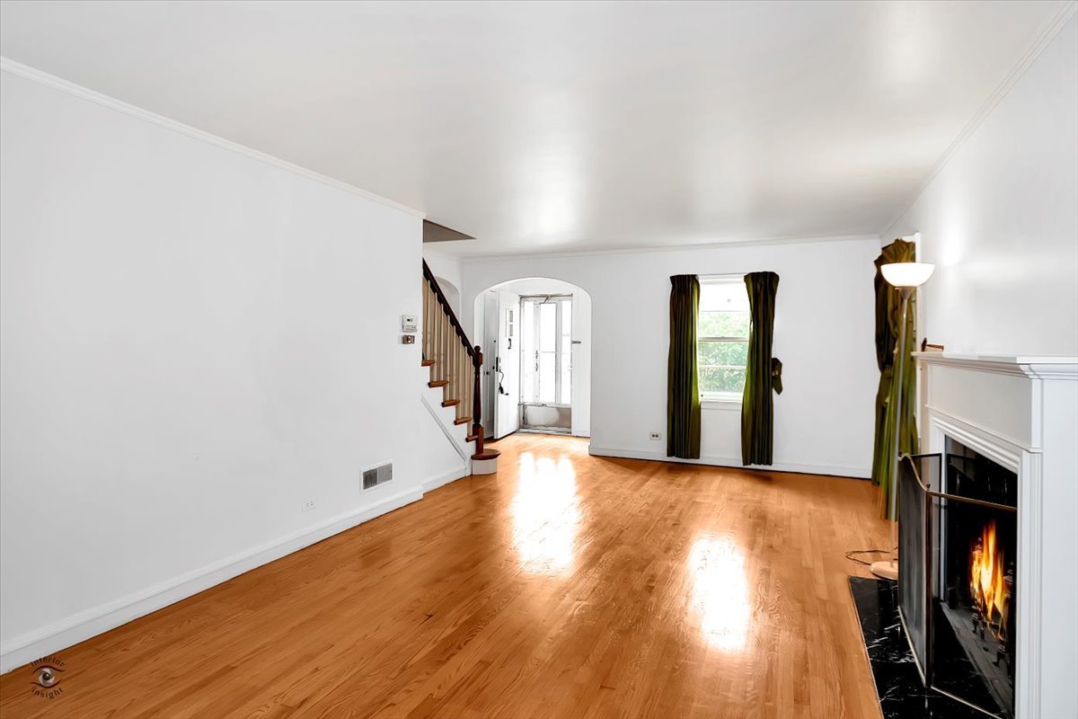 9527 South Damen Avenue Chicago, IL 60643 - Photo 7 of 30 a view of an empty room with wooden floor and a window