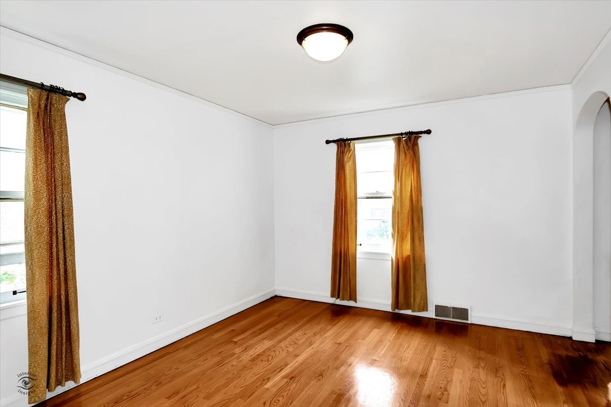 9527 South Damen Avenue Chicago, IL 60643 - Photo 9 of 30 a view of an empty room with wooden floor and a window