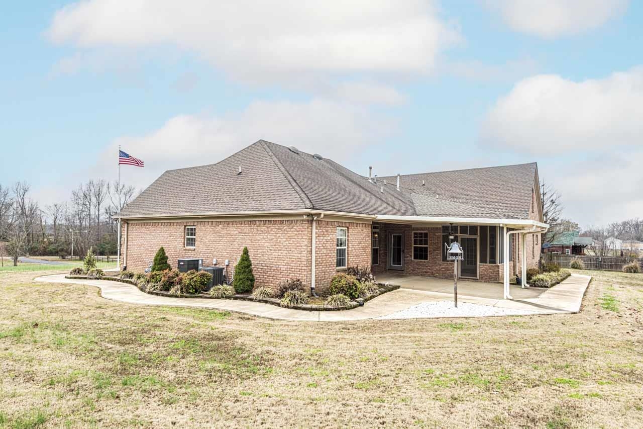3876 West Union Road Millington, TN 38053 - Photo 15 of 40 Back of property with brick siding, a patio area, and a shingled roof