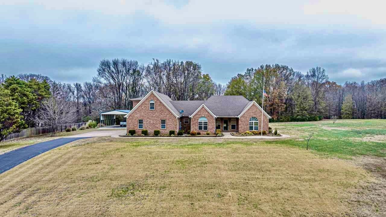 3876 West Union Road Millington, TN 38053 - Photo 23 of 40 View of front facade featuring concrete driveway, brick siding, and covered porch