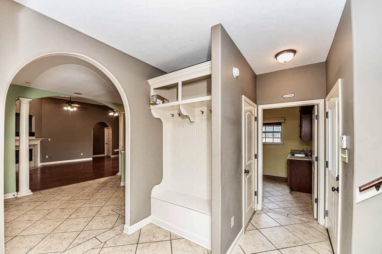 3876 West Union Road Millington, TN 38053 - Photo 33 of 40 Mudroom featuring light tile patterned flooring, a ceiling fan, and arched walkways