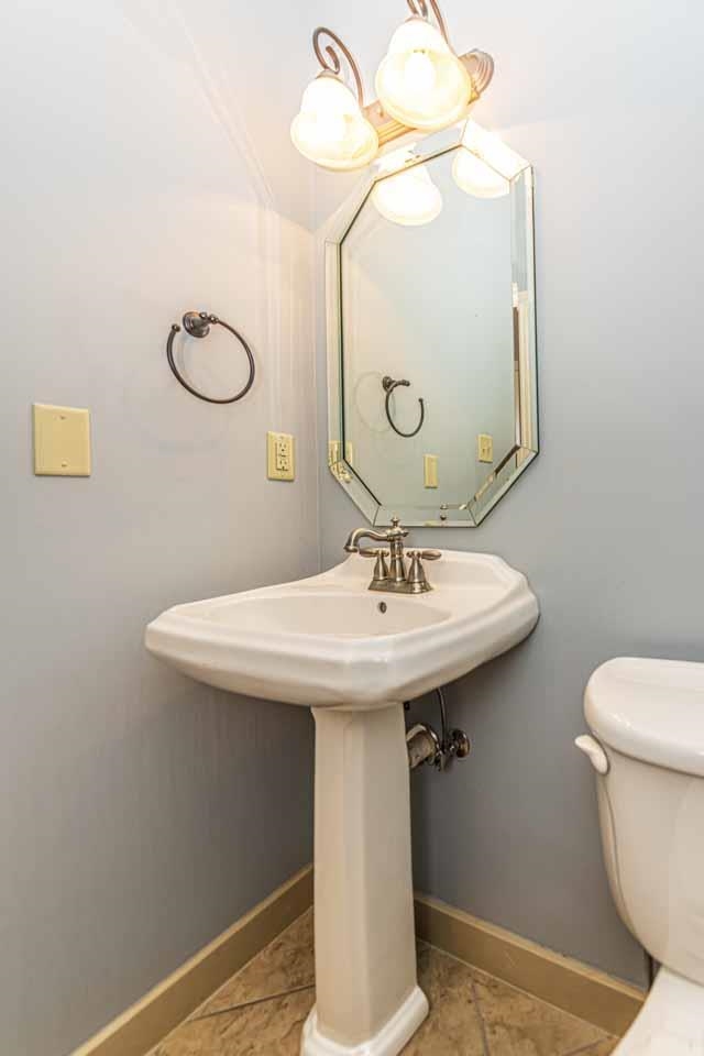 3876 West Union Road Millington, TN 38053 - Photo 35 of 40 Half bathroom with toilet and light tile patterned floors