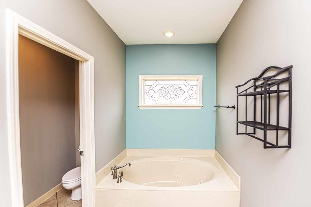 Bathroom featuring a garden tub, tile patterned flooring, and recessed lighting