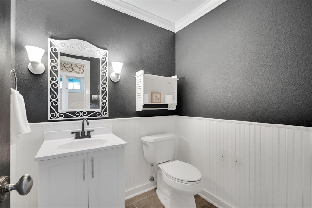 3052 Keri Lane Midlothian, TX 76065 - Photo 16 of 40 a bathroom with a toilet a sink and mirror