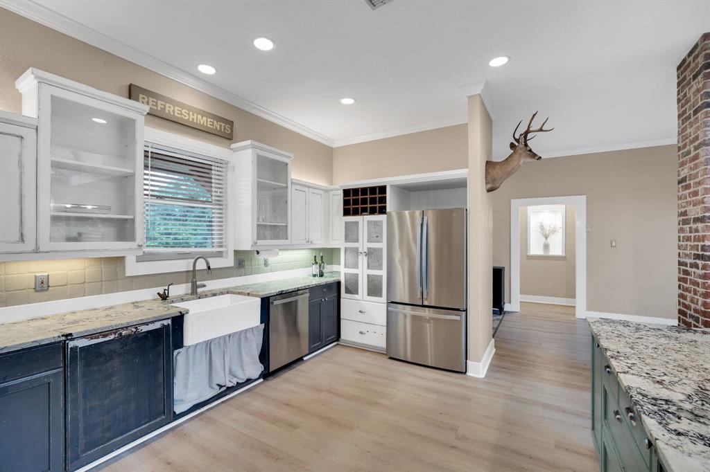 3052 Keri Lane Midlothian, TX 76065 - Photo 9 of 40 a kitchen with stainless steel appliances granite countertop a refrigerator a sink dishwasher a stove with wooden cabinets and floor