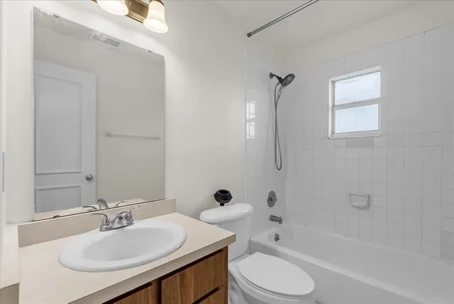 a bathroom with a sink toilet tub and shower