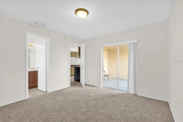 an empty room with windows and closet