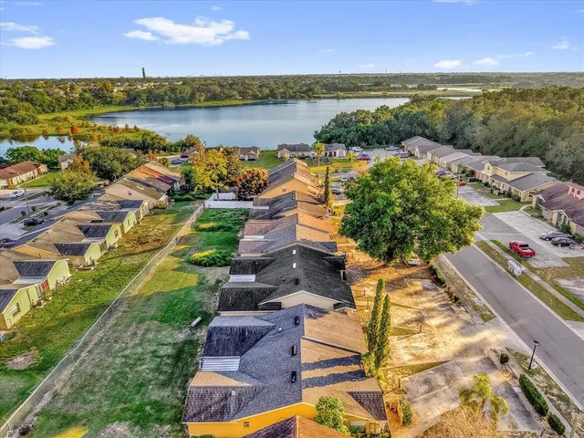 an aerial view of a residential houses with outdoor space and seating