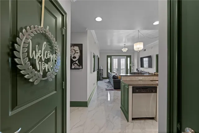 a dining hall with stainless steel appliances granite countertop a refrigerator and a stove top oven