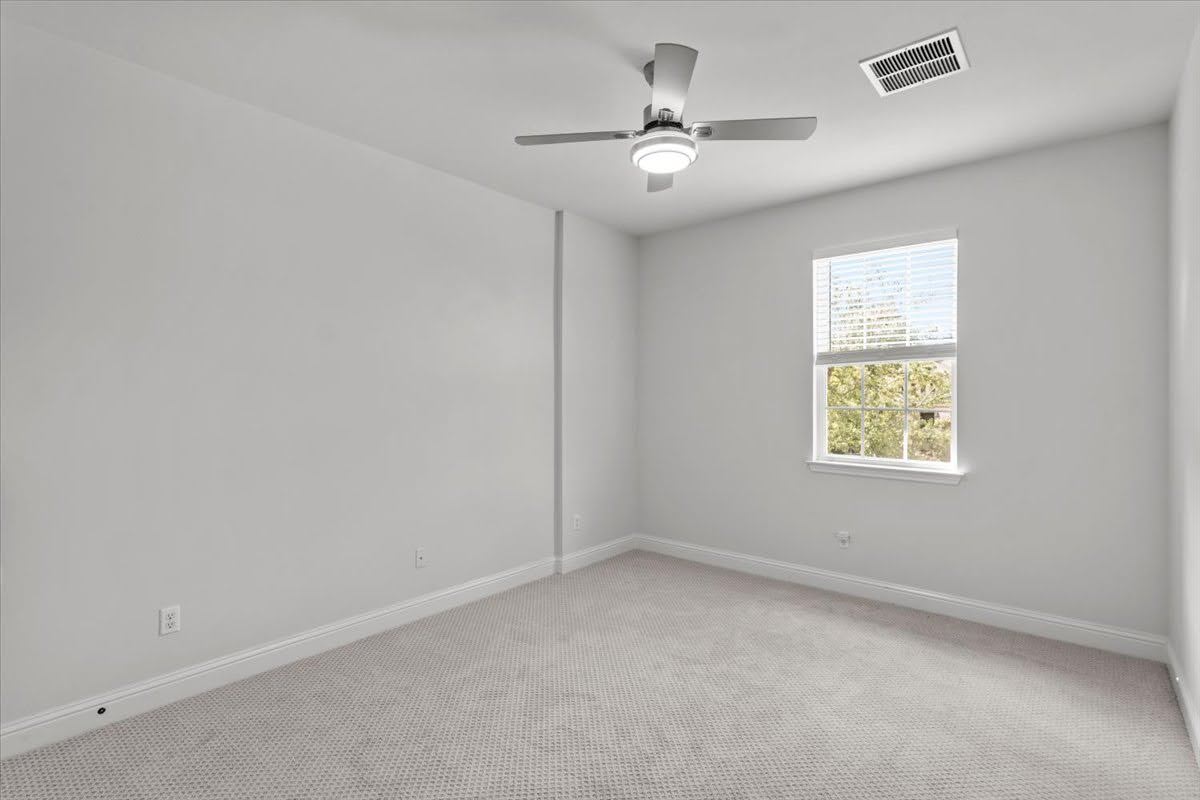 4108 Bison Bend, Unit FOR RENT Cedar Park, TX 78613 - Photo 28 of 36 Bedroom 3 upstairs. A well-lit bedroom with fresh, neutral tones and a broad window offers a serene retreat.