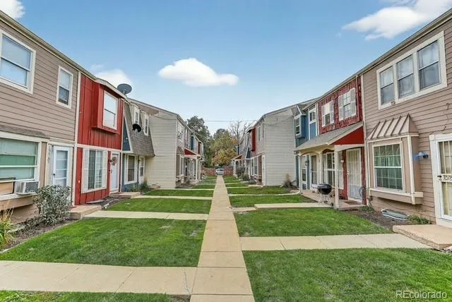 a front view of building with yard and green space