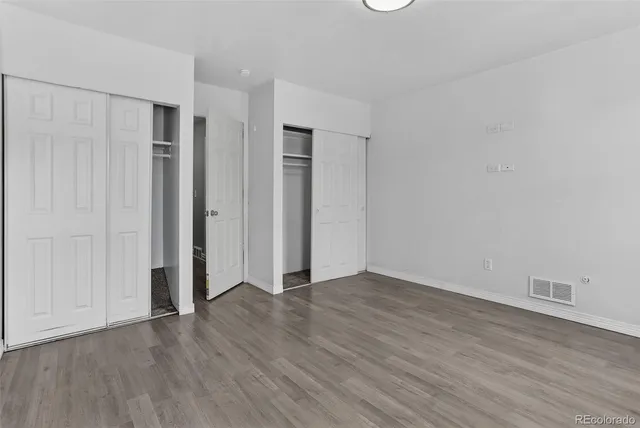 a view of an empty room with wooden floor