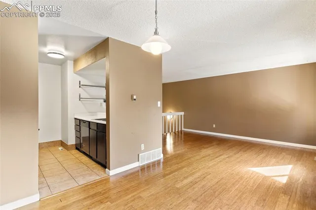 a view of a hallway with wooden floor and a fireplace