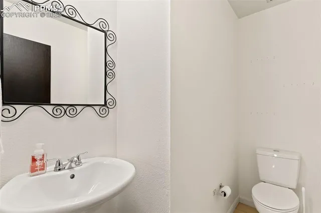 a white toilet sitting next to a white sink