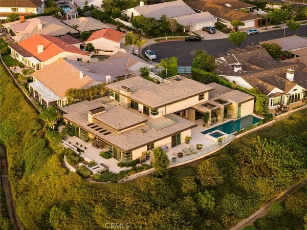 an aerial view of a house with a swimming pool