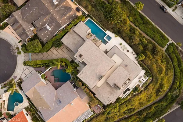 a backyard of a house with plants and palm trees