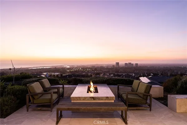 a view of a roof deck with furniture