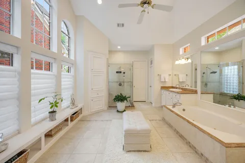 a spacious en suite bathroom with a double vanity sink double and mirror