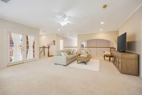 a utility room with granite countertop white cabinets and a stove top oven