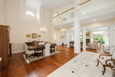 a living room with furniture a fireplace and wooden floor