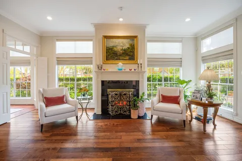 a large white kitchen with stainless steel appliances granite countertop a stove and a sink