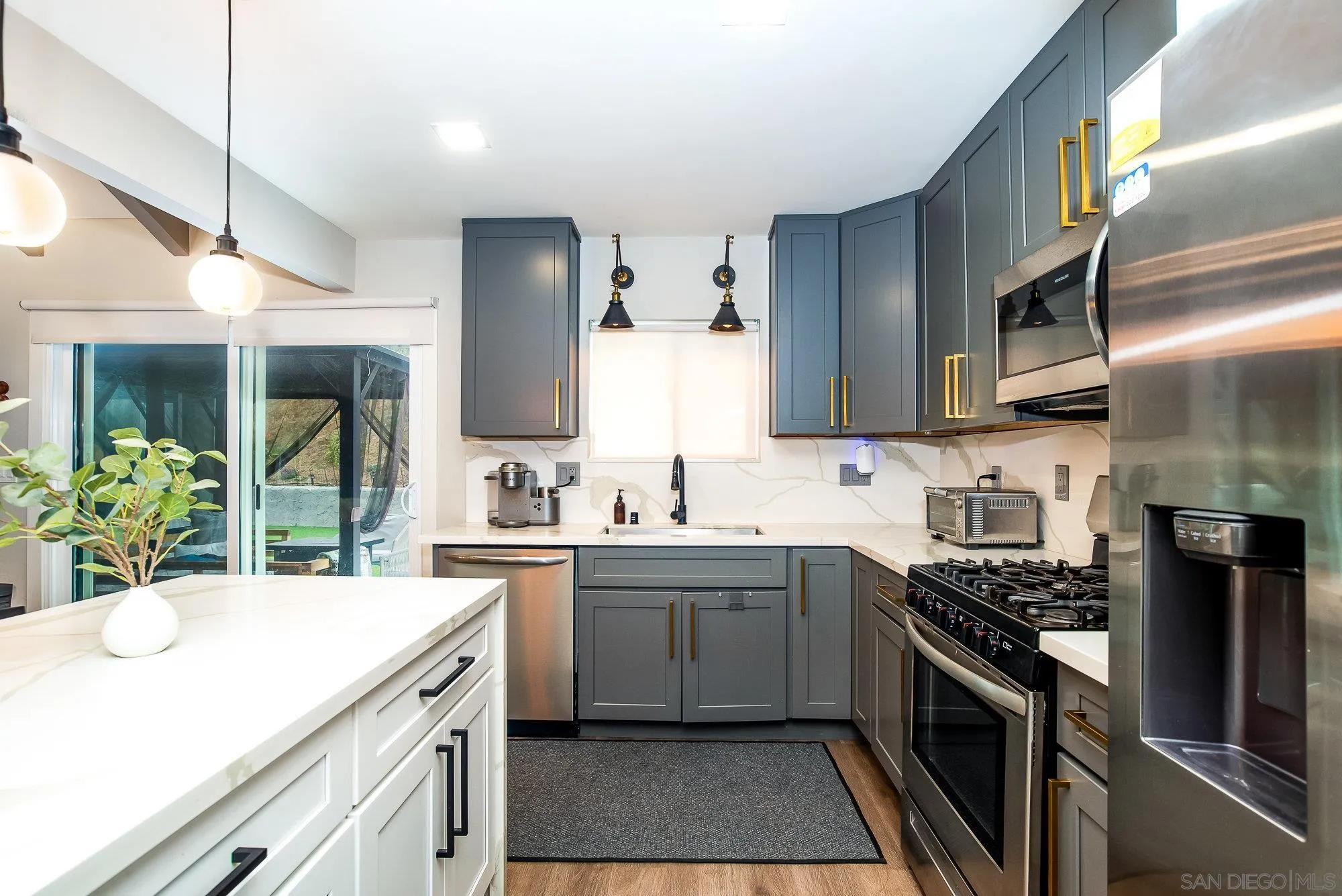 10753 Valor Place Santee, CA 92071 - Photo 13 of 24 a kitchen with stainless steel appliances a sink stove and cabinets