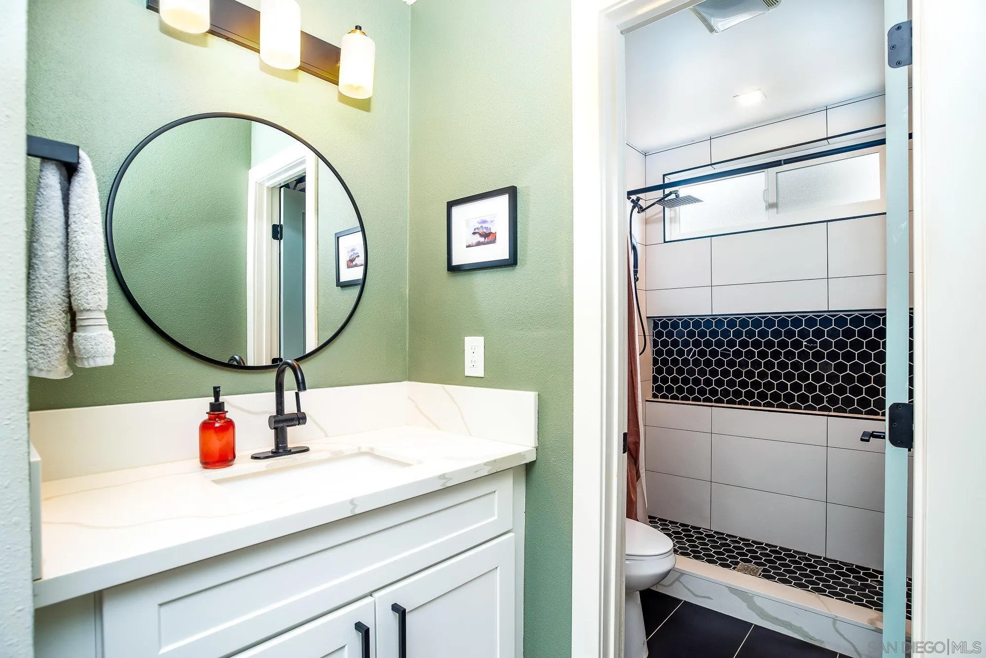 10753 Valor Place Santee, CA 92071 - Photo 15 of 24 a bathroom with a sink a mirror and shower