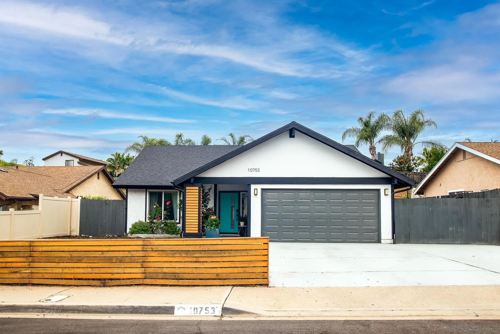 10753 Valor Place Santee, CA 92071 - Photo 2 of 24 a front view of a house with a yard and garage