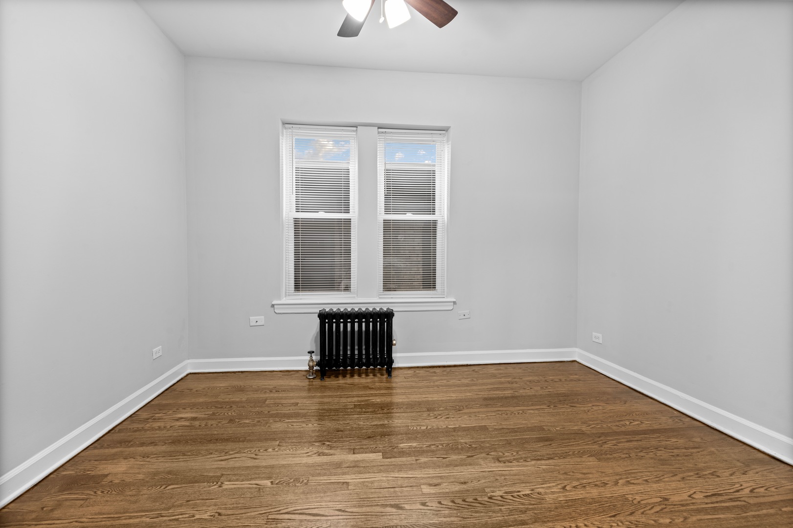 1724 West Juneway Terrace, Unit 3A Chicago, IL 60626 - Photo 7 of 9 wooden floor and window in an empty room
