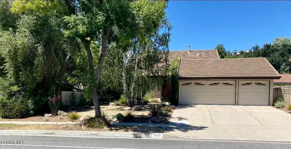 a view of a house with a bench