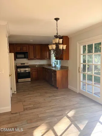 a kitchen with stainless steel appliances granite countertop a stove and a sink