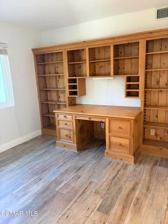 a kitchen with stainless steel appliances a stove and wooden floor