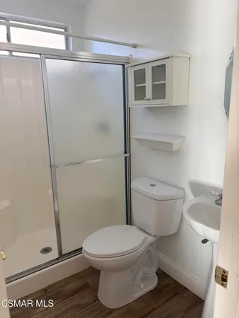 a bathroom with a toilet and a shower