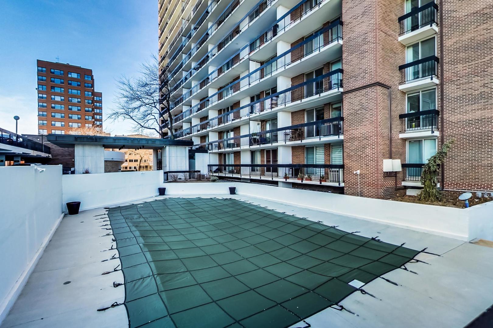 5901 North Sheridan Road, Unit 6K Chicago, IL 60660 - Photo 33 of 39 a front view of a residential apartment building with a yard