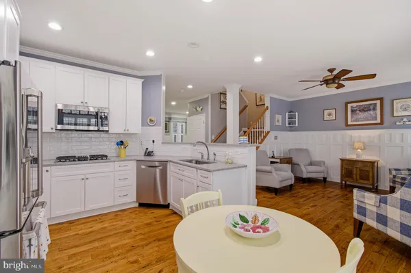 a kitchen with stainless steel appliances granite countertop a refrigerator and a stove top oven