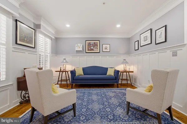 a living room with furniture a rug and a fireplace