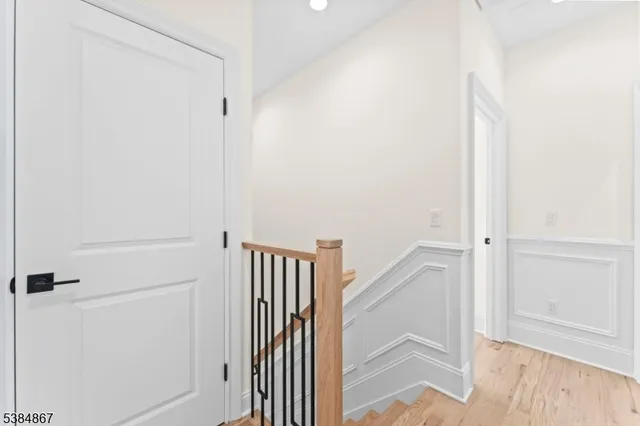 a view of a hallway with white walls and door