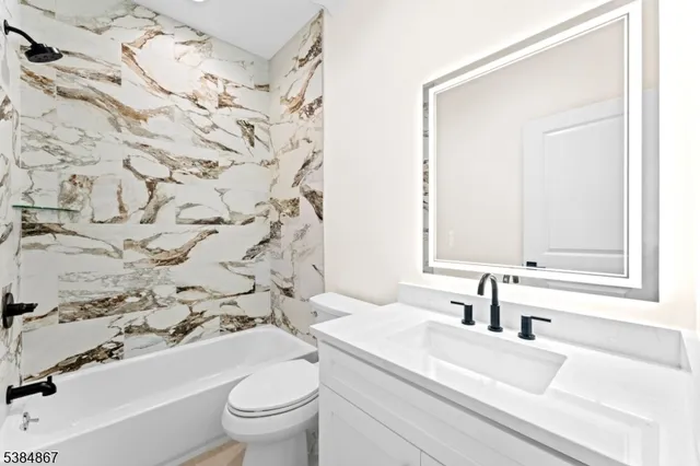 a bathroom with a sink a toilet and a mirror