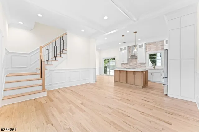 a view of kitchen with wooden floor and electronic appliances