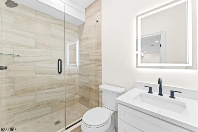 a white toilet sitting next to a bathroom sink