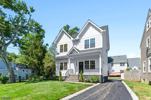 a front view of a house with a yard and porch