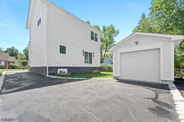 a view of a house with a yard and garage
