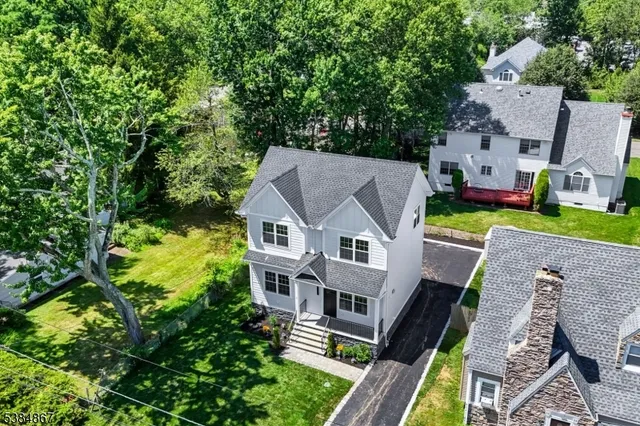 an aerial view of a house with a yard table and chairs