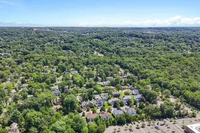 an aerial view of a houses with a yard