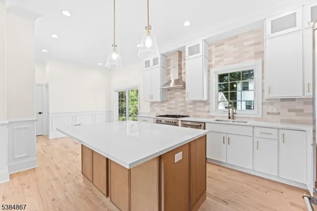 a kitchen with a sink window and cabinets