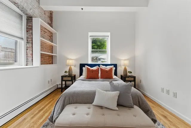 a bedroom with bed and window